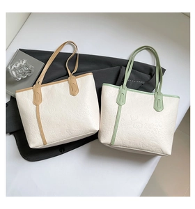 Detail of embossed tote bags featuring cute heart patterns in khaki and mint green trim