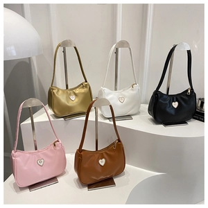 Collection of minimalist crescent underarm bags in five colors with heart hardware detail