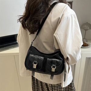 Vintage black oil wax leather shoulder bag with multi-pocket design shown on model