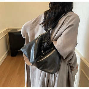 Detail view of the black soft leather hobo bag showing the large capacity and texture