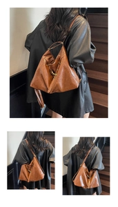 Close-up of vintage brown leather bag with brass hardware and adjustable straps