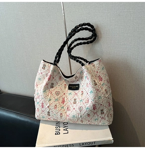 Close-up of pleated bubble fabric tote bag with cute bear patterns and woven handles