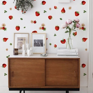 Realistic strawberry and floral wall decals applied on a white wall in a cozy room decor