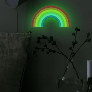 Glow in the dark rainbow wall lamp for home decor in a dim light bedroom setting