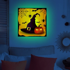 Luminous Halloween wall decor featuring a wizard hat, pumpkin, and bats in a dark bedroom