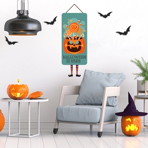 Halloween wall sign with pumpkin candy bucket design and 3D striped legs decoration