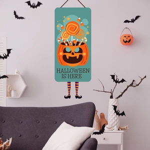 Detail of Halloween banner showing a pumpkin bucket and funny legs on a white wall