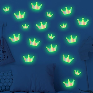 Luminous crown wall stickers glowing green in a dark bedroom setting for kids room decor