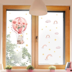 Detail of pink hot air balloon bear window sticker on a wooden frame glass background