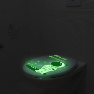Luminous astronaut toilet sticker glowing in dark with warning text for bathroom decor