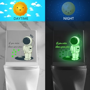 Luminous astronaut toilet decal showing day and night glowing effect comparison
