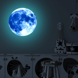 Close-up of a blue glowing moon wall sticker with realistic textures in a dark room