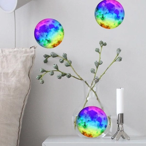 Close-up of colorful nebula glow-in-the-dark moon wall stickers in a home interior setting