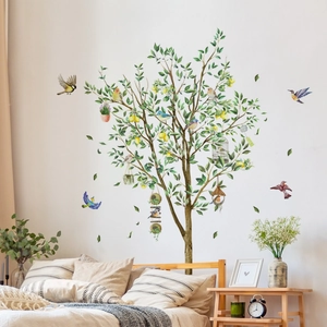 Watercolor lemon tree wall sticker with birds displayed in a cozy bedroom setting