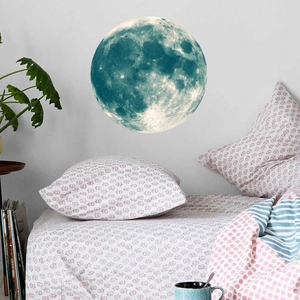 Detailed view of a large glowing moon wall sticker with realistic lunar surface texture