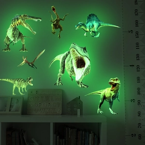 Detailed view of luminous dinosaur wall stickers glowing green in a kids bedroom setup
