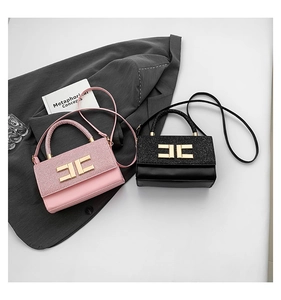 Detail showing pink and black crossbody bags with gold logo and contrasting textures