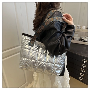 Quilted silver tote bag with retro jacquard strap shown on shoulder for daily commute