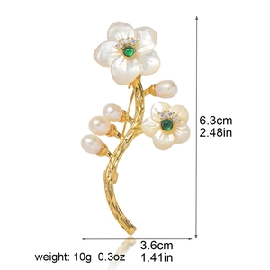 Broche fleur élégante avec pétales de nacre, pierre verte et perles sur fond blanc