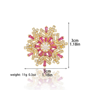 Rotating golden snowflake brooch with pink gemstones and white zircons, size 3cm