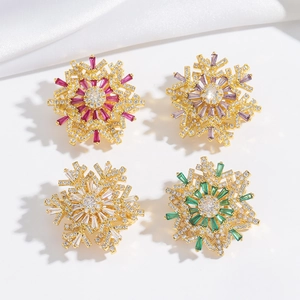 Rotating snowflake brooches with colorful zircon crystals in gold-plated settings