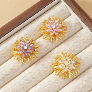 Vue détaillée de trois mini broches marguerites en cristal en violet, rose et blanc