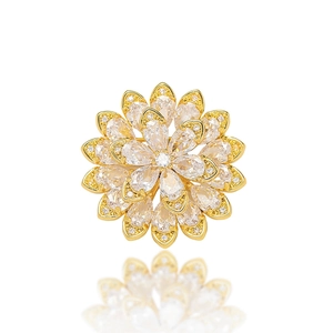 Close-up of golden daisy brooch featuring layered petals and sparkling zircon crystals