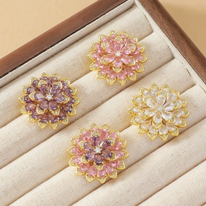 Exquisite crystal daisy brooch set in colorful gemstones with a floral jewelry display