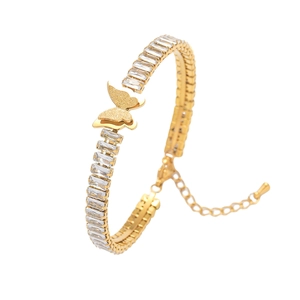 Macro detail of gold butterfly bracelet featuring clear baguette zirconia and extension chain