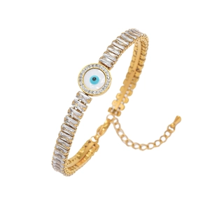 Detail of gold evil eye bracelet featuring rectangular crystals and adjustable chain