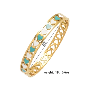 Detail view of 19g gold hollow heart bangle with enamel inlay showing 6cm inner diameter