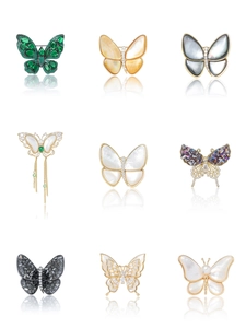 Macro display of nine distinct natural mother-of-pearl butterfly brooches with zircon details