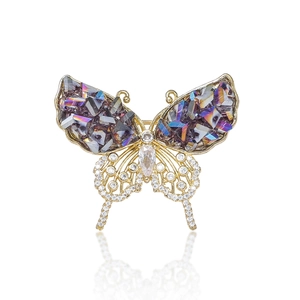 Macro shot of butterfly brooch with purple crystals and sparkling zircon wings