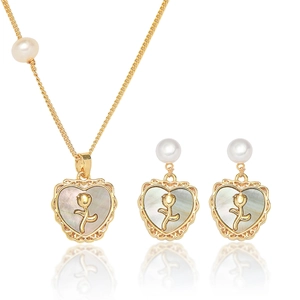 Close-up of gold heart pendant set with mother of pearl and a delicate rose detail