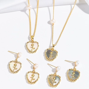 Elegant heart rose shell necklace and earrings set with pearl accents in gold finish