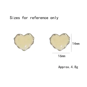 Elegant minimalist heart stud earrings with cream shell texture and irregular gold border