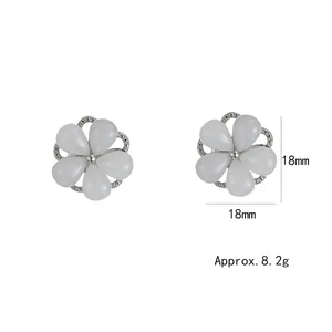 Elegant rotating cat eye stone flower stud earrings with silver metal and zircon accents