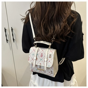 Close-up of women's mini backpack with pink rabbit and bear prints and gold logo plate