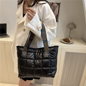 Quilted black puffer tote bag for women with a colorful ethnic style wide shoulder strap