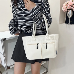 Minimalist white nylon tote bag with dual front zipper pockets for daily commuting use