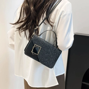 Retro black crossbody square bag with glitter flap and gold buckle on a fashion model