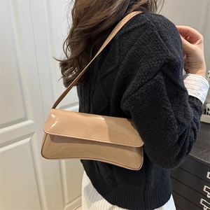 Elegant beige glossy patent leather underarm bag with minimalist shoulder strap style