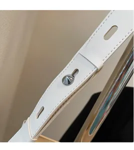 Detail of adjustable white leather shoulder strap with silver studs and neat stitching