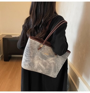 Detailed view of the large capacity shoulder tote bag shown on model in a home setting