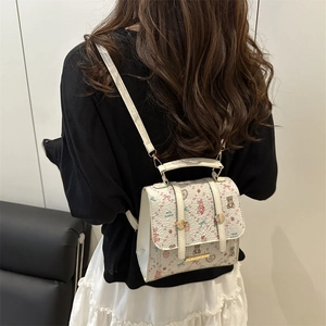 Fashionable white leather backpack with cartoon patterns and gold metal buckle hardware
