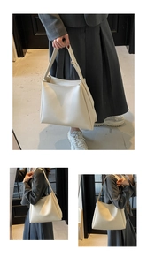 Detail showing the large capacity and wide strap design of the minimalist cream tote bag
