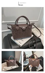 Detail of leopard print handbag with leather flap and adjustable shoulder strap