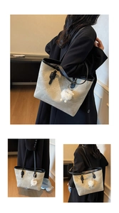 Detail of grey marble pattern tote bag with black handles and white sheep charm