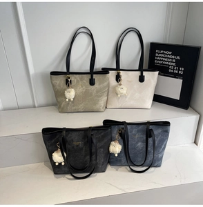 Detail view of four large tote bags with marble textures and cute sheep charms