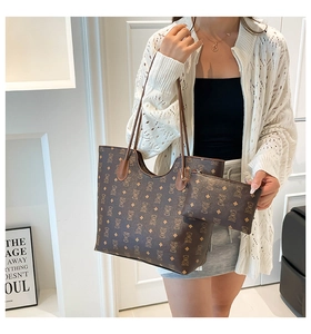 Détail du sac cabas marron avec motif d'ours et sa pochette zippée assortie de luxe